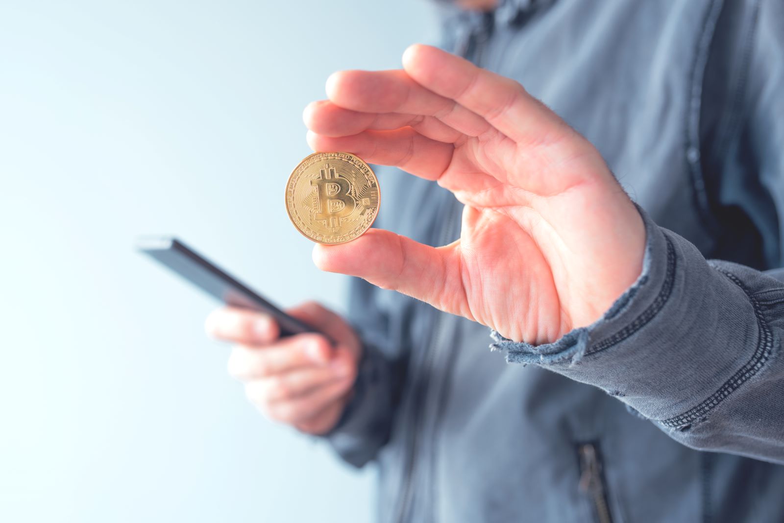 man holding bitcoin